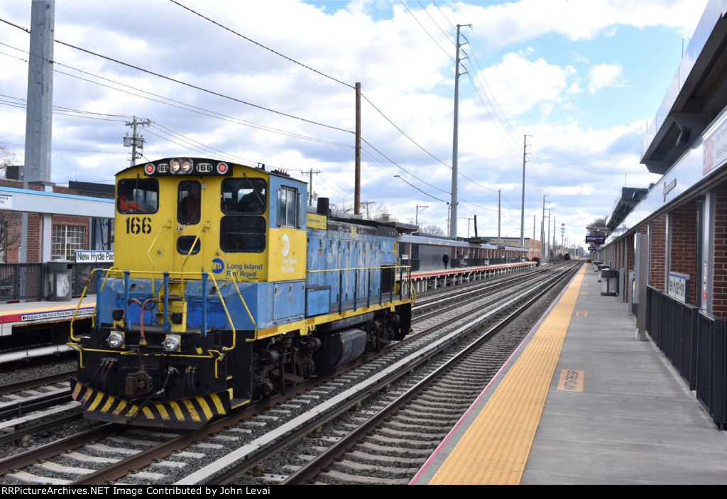 MP15AC # 166 running solo westbound 